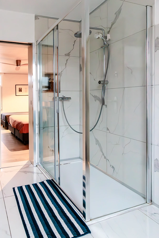 Modern ensuite bathroom with rain shower at Bob's BnB Bruges